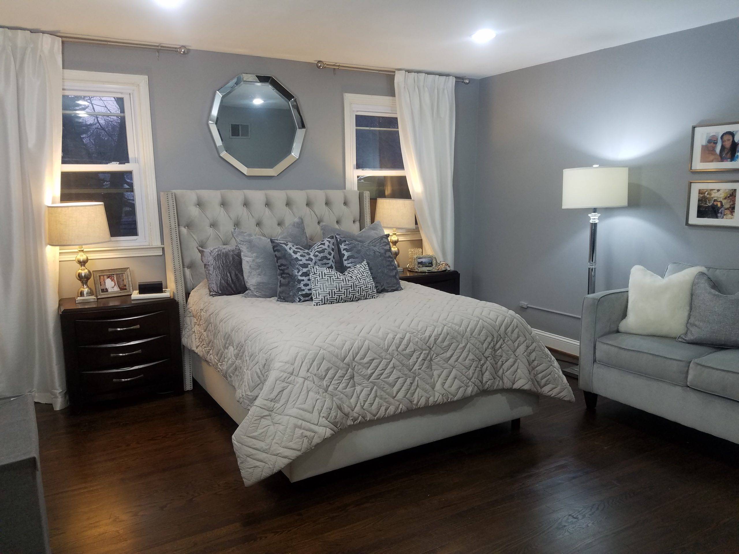 blue bedroom with silver decor and wood flooring