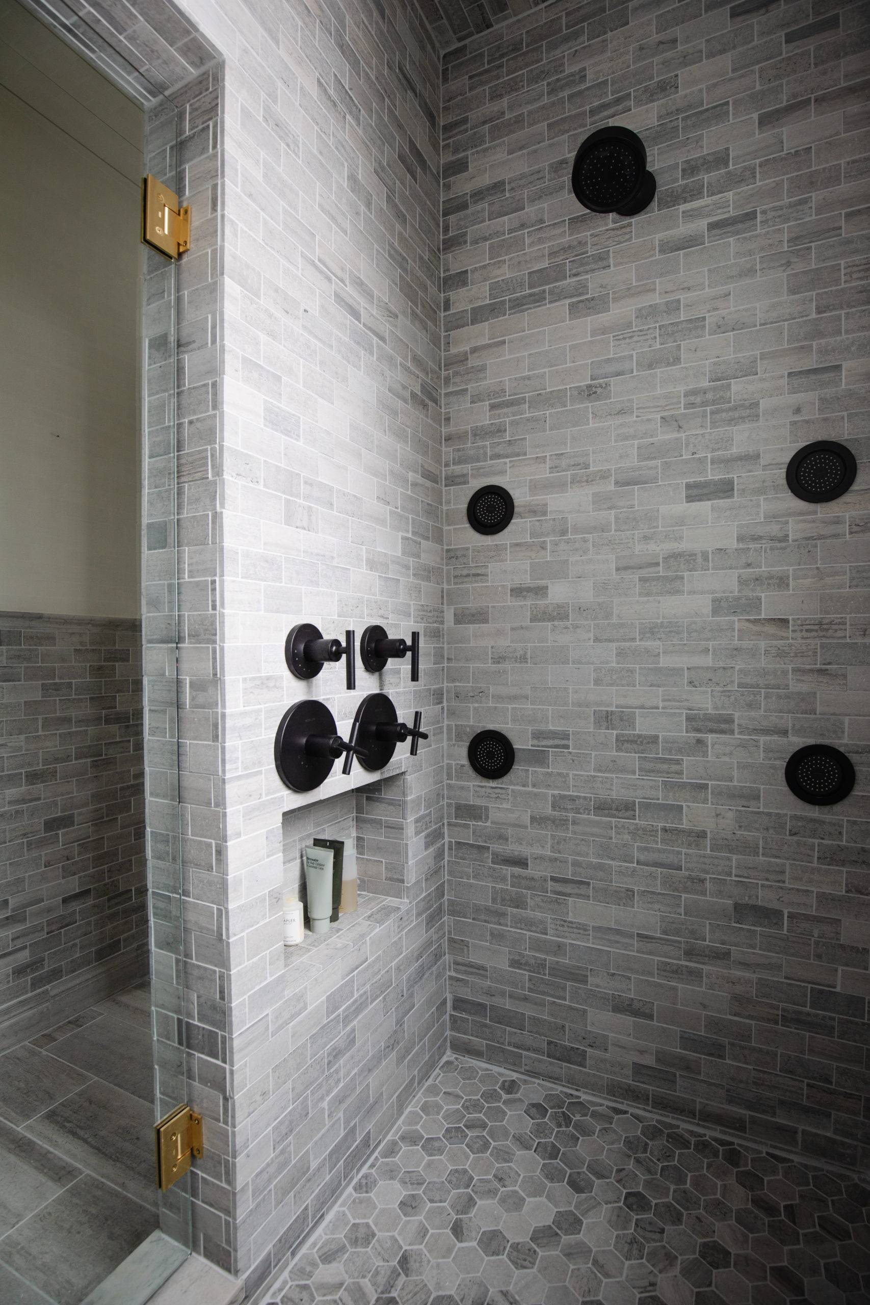 Modern shower with grey limestone tiled walls and floor