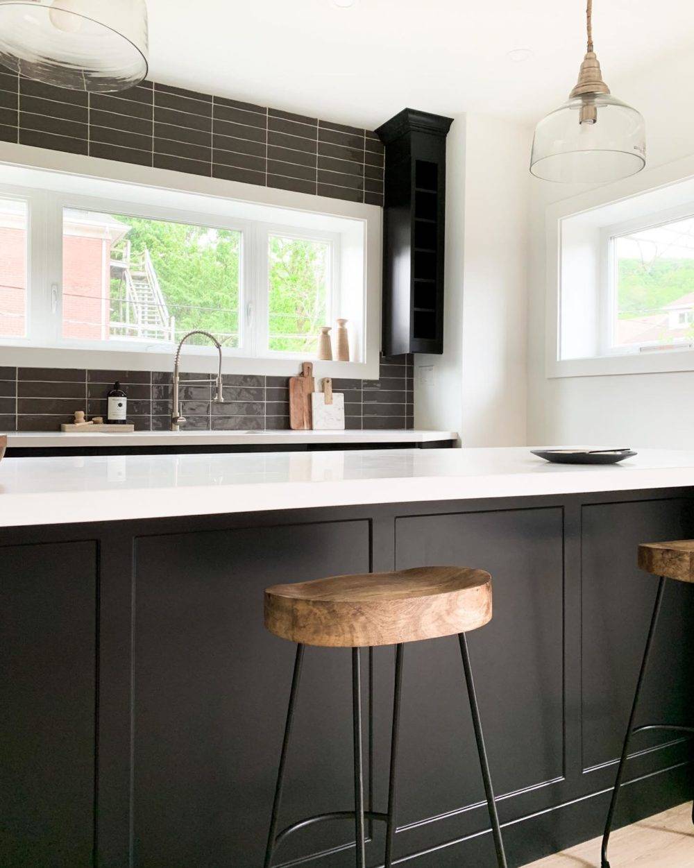 modern black and white kitchen with black tiled backsplash