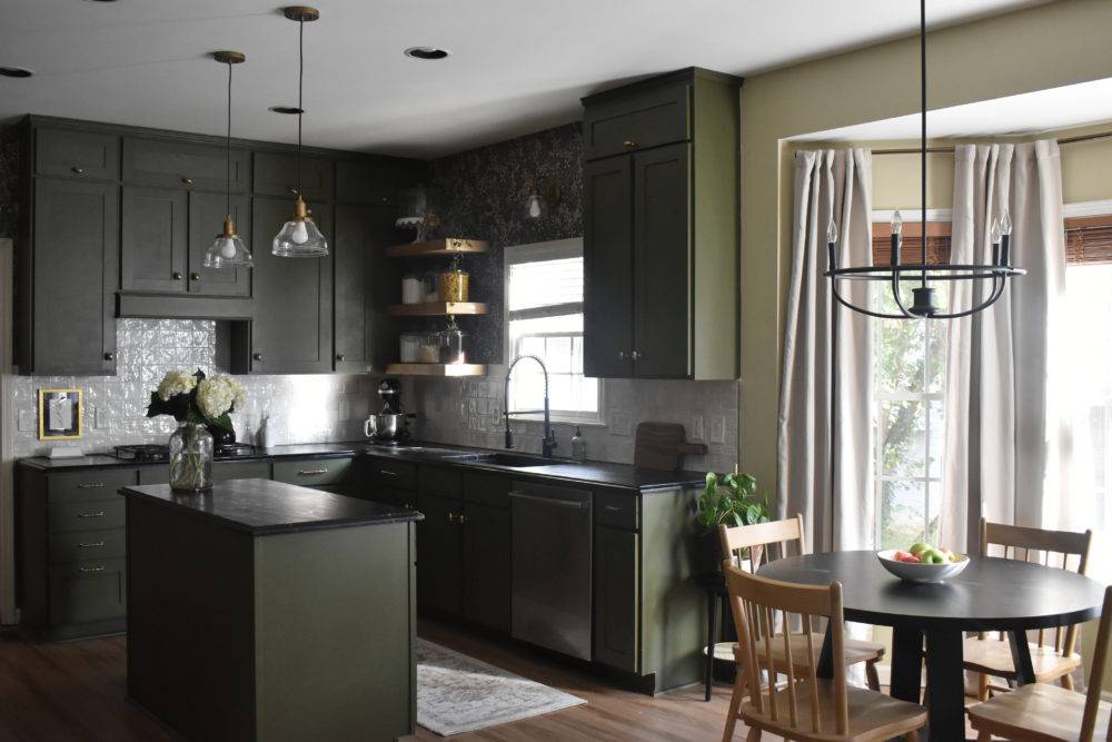 Moody kitchen with olive green cabinetry and white handmade-look square tiled backsplash