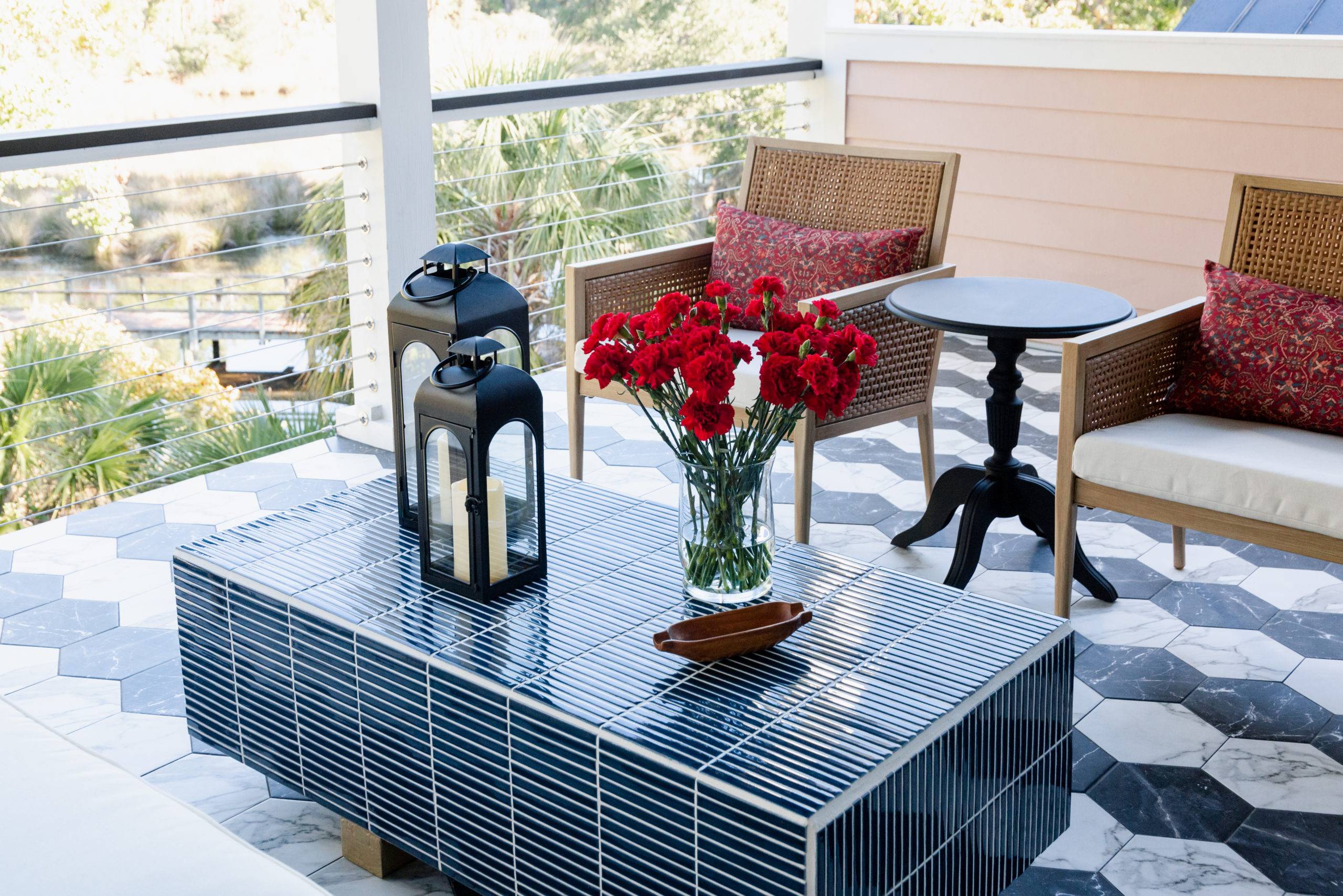 Porch with black and white tiled hexagon flooring and tiled outdoor coffee table