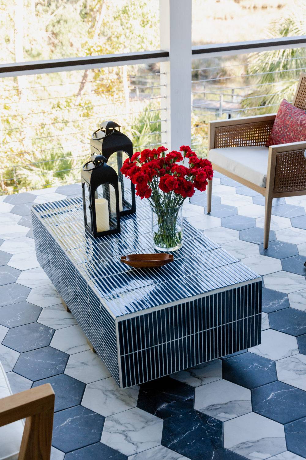 Porch with black and white tiled hexagon flooring and tiled outdoor coffee table