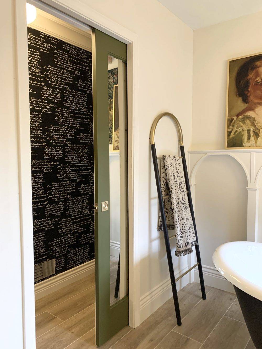 Traditional bathroom with wood-look tile flooring and green pocket door