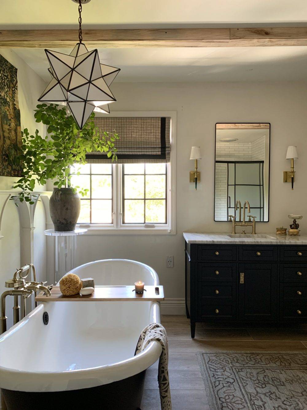 Traditional primary bathroom with wood-look tile flooring and black cabinetry