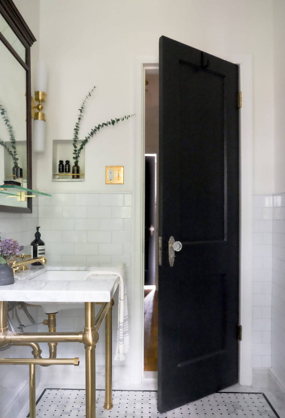 Elegant tiled bathroom with marble flooring and white subway tile backsplash