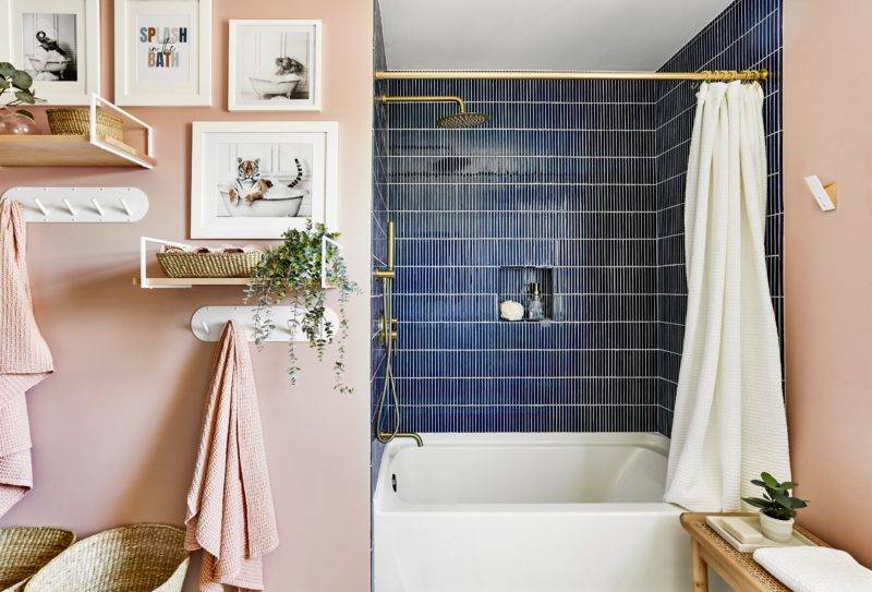 Kids bathroom with pink walls and navy blue stacked shower tile