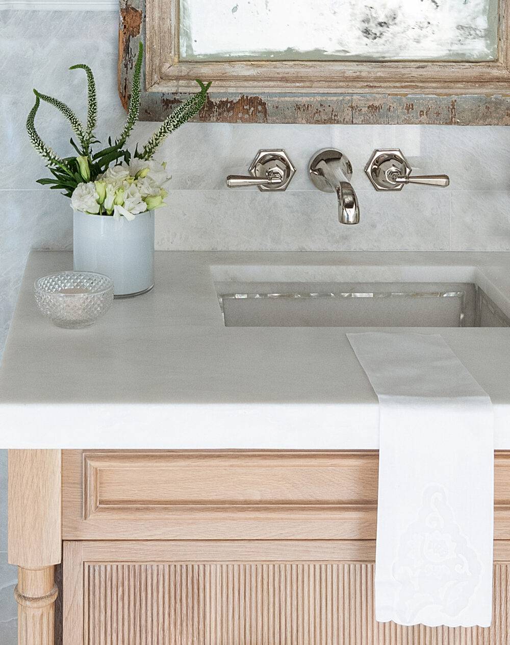 Powder room sink featuring Meram Blanc Carrara Polished tile. 
