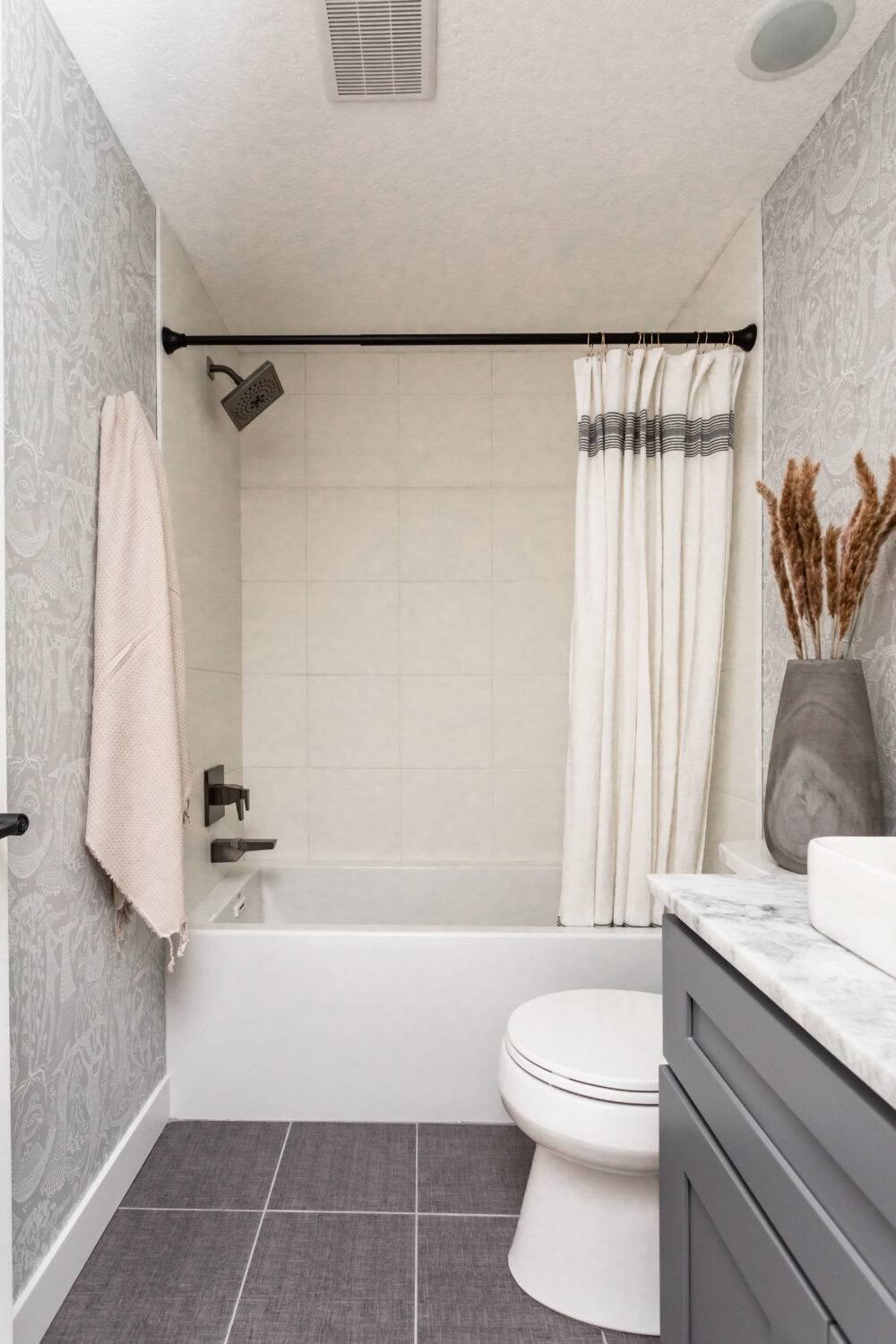 Bathroom with grey large-format floor tiles. 
