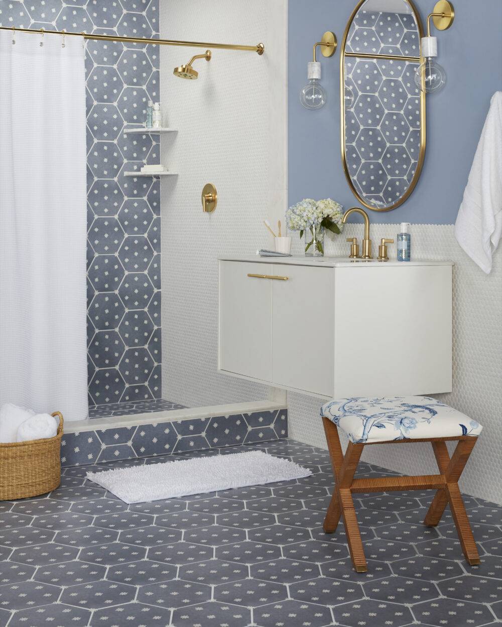 Bathroom with blue with small white start patterned hexagonal tile and small white hex on the walls. 