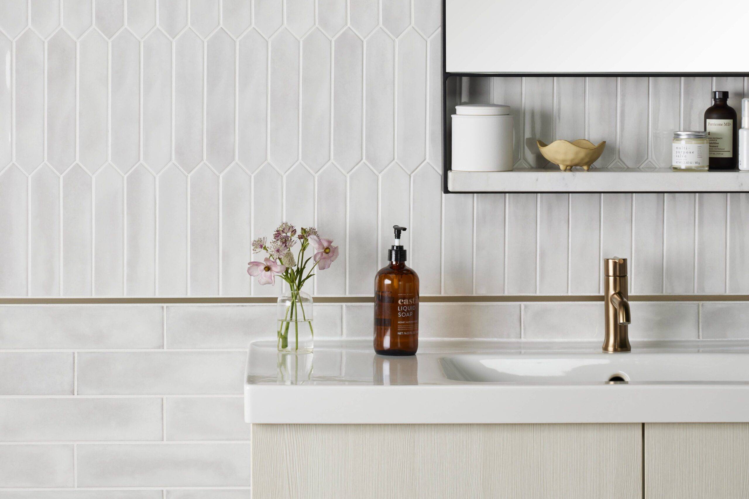 Bathroom with white subway tile and white picket tile. 