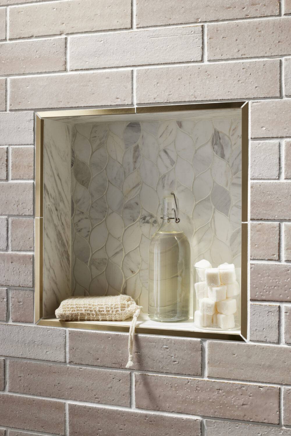 Brick-look subway tile and marble mosaic shower niche. 