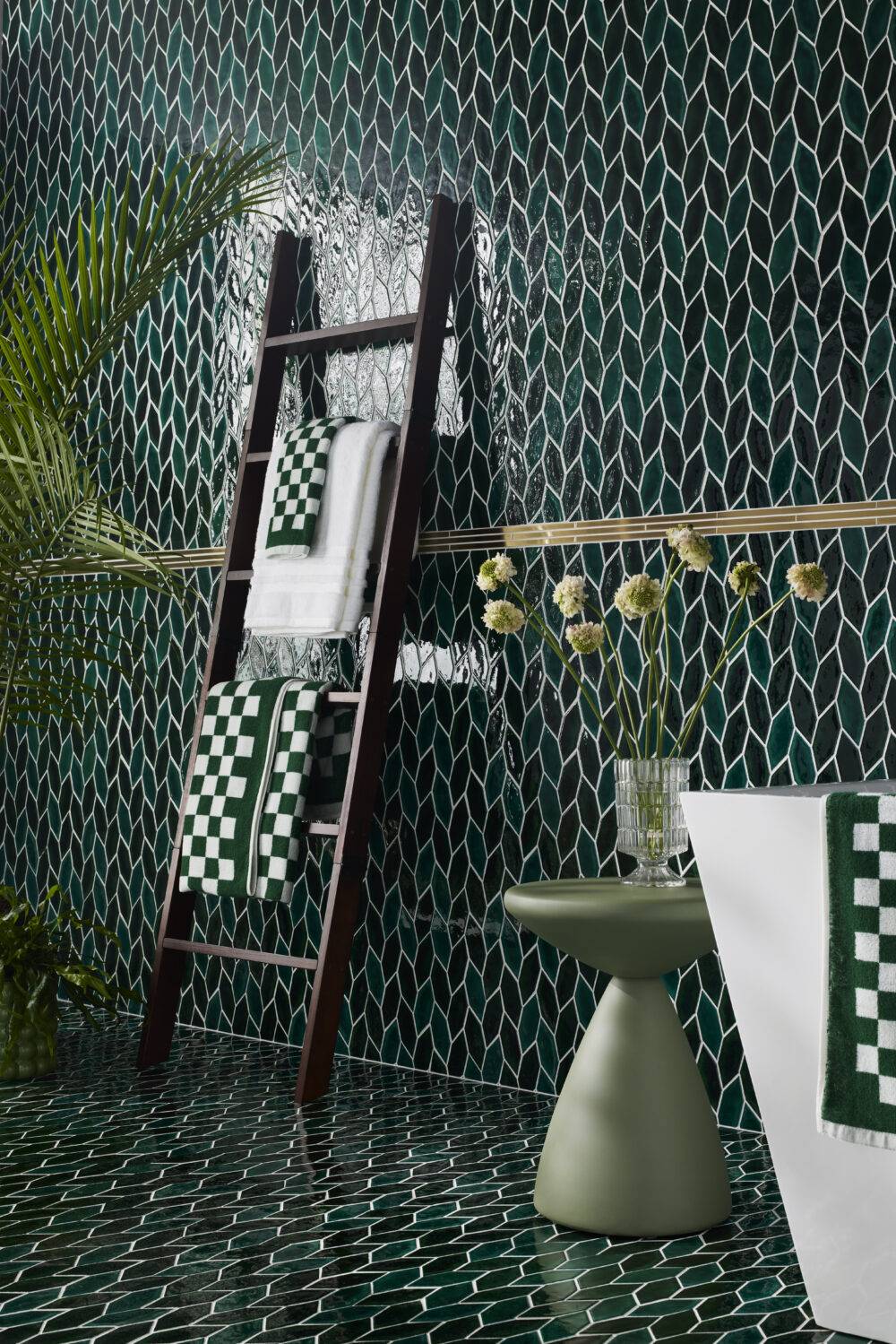 Bathroom with green leaf-shape tile wall and floor. 