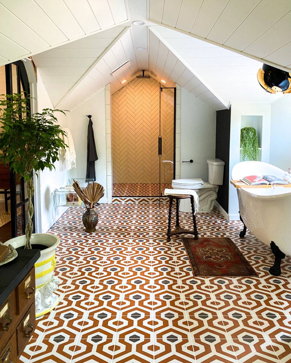 Bathroom with orange and charcoal-colored geometric patterned tile. 