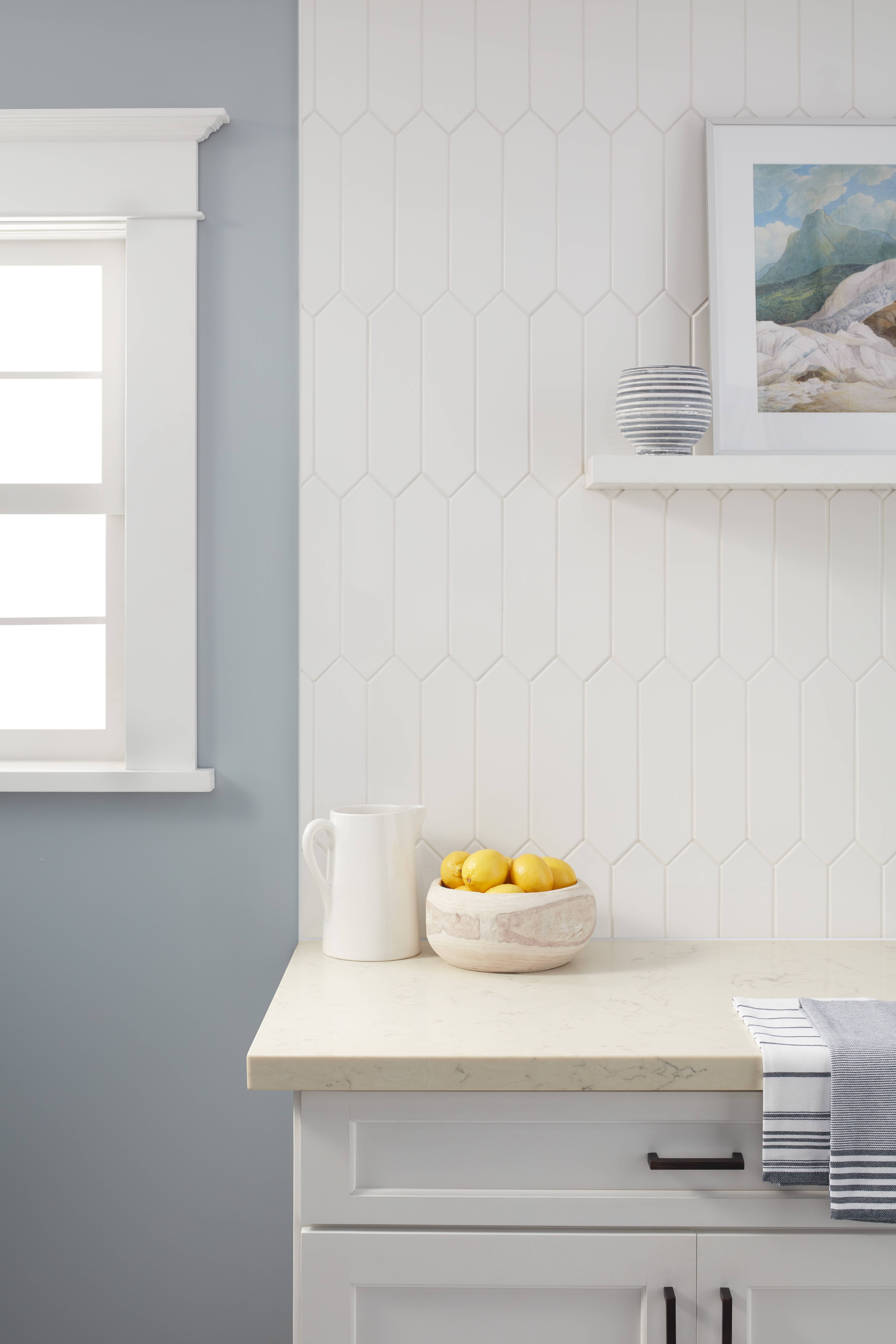 A kitchen wall with white picket tile. 
