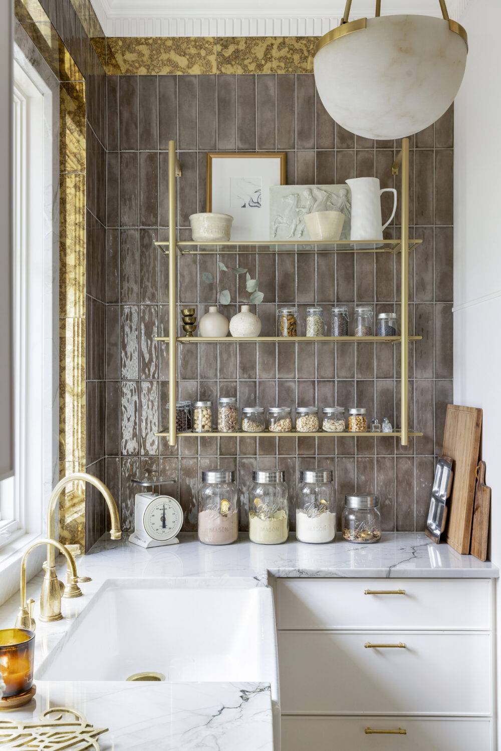 Kitchen pantry with handmade-look subway tile with gold patina mirrored tile boarder. 