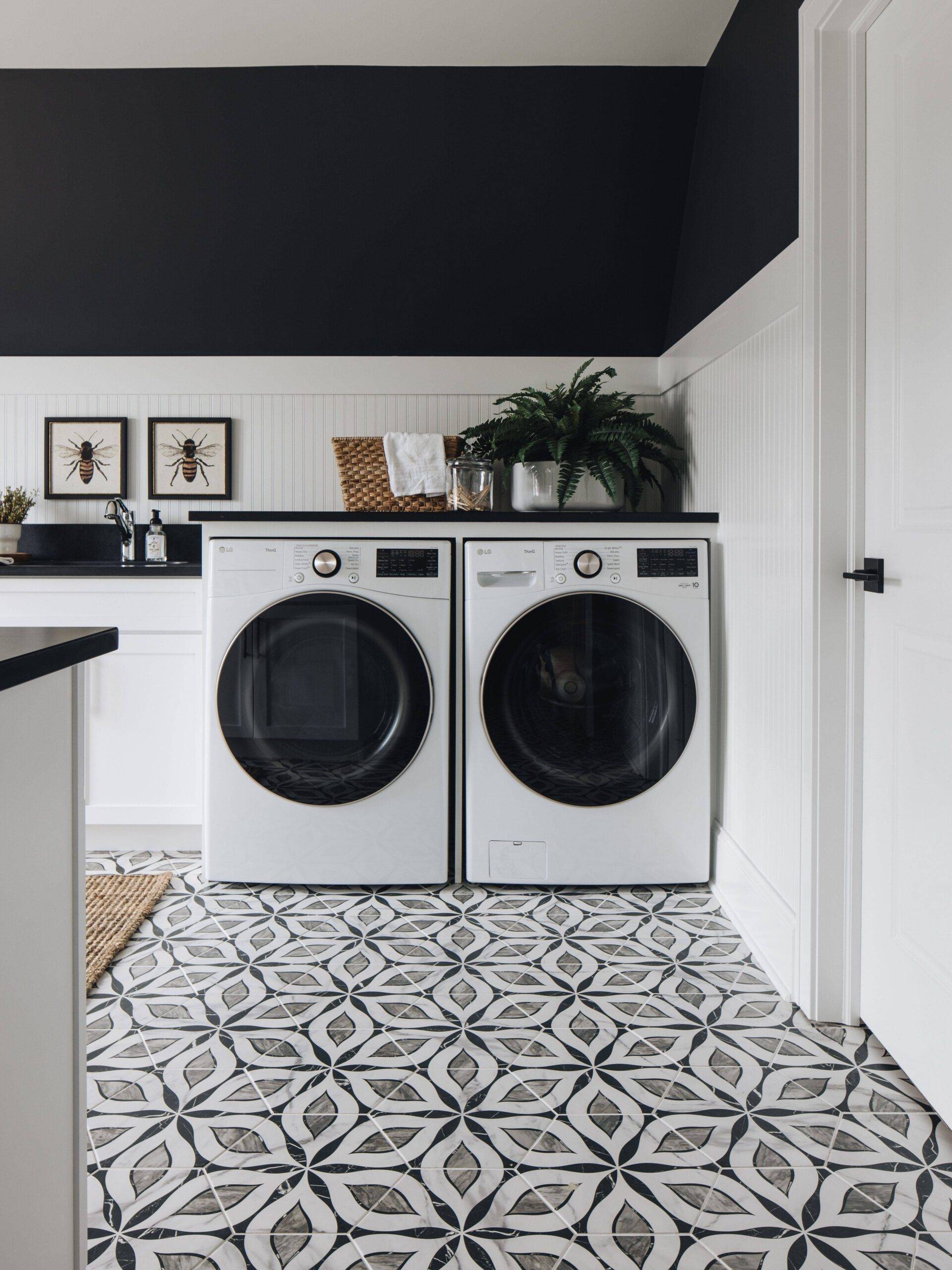 Laundry room with floral-patterned grey, white and black hexagon-shaped tile floor.