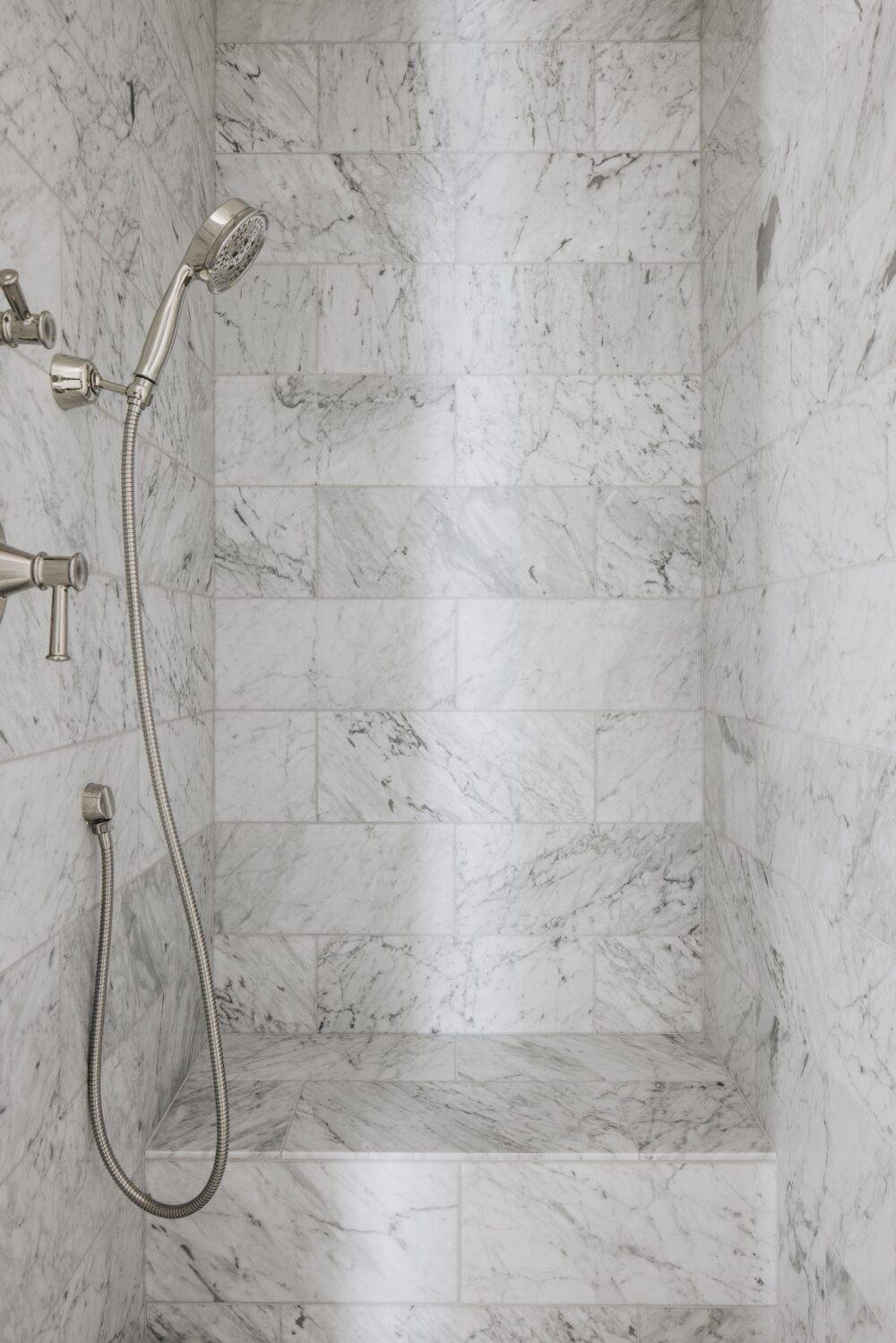 White marble with grey veining shower walls. 