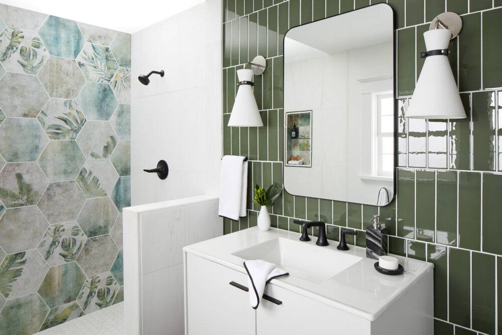 Hexagonal porcelain tile with green tones and floral print on wall. Green glass tile on backsplash.