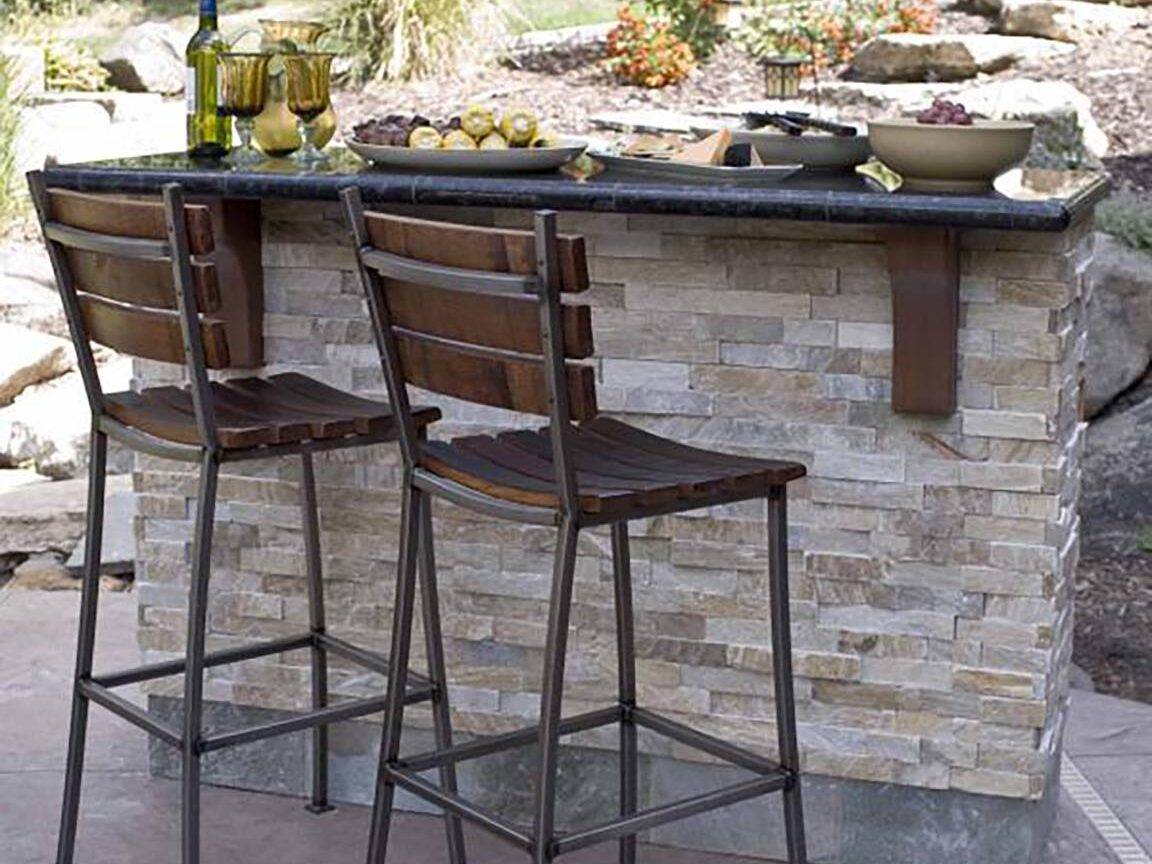 Architectural tile outdoor bar area with bar stools.