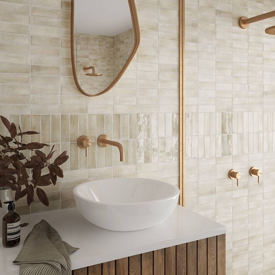 Bathroom with beige horizontal matte subway tile and a double stripe of glossy subway tile. 
