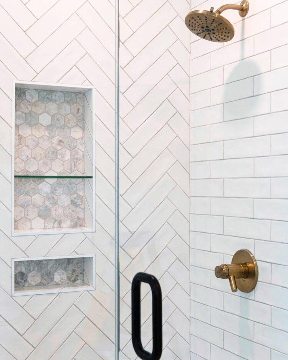 Shower with white subway tile in herringbone and brick bond patterns.
