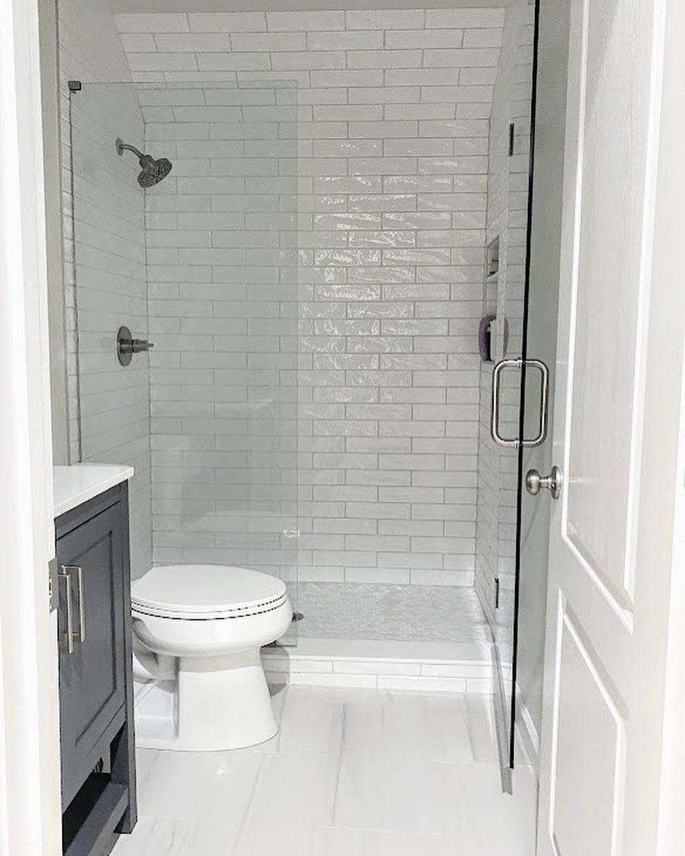 Shower with white subway tile.
