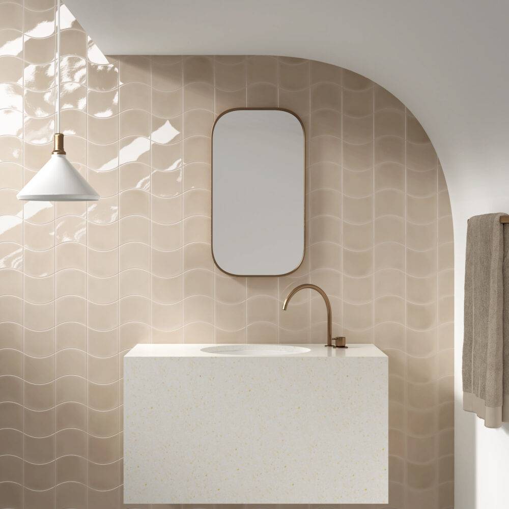 Bathroom wall with cream-colored, curved tile.