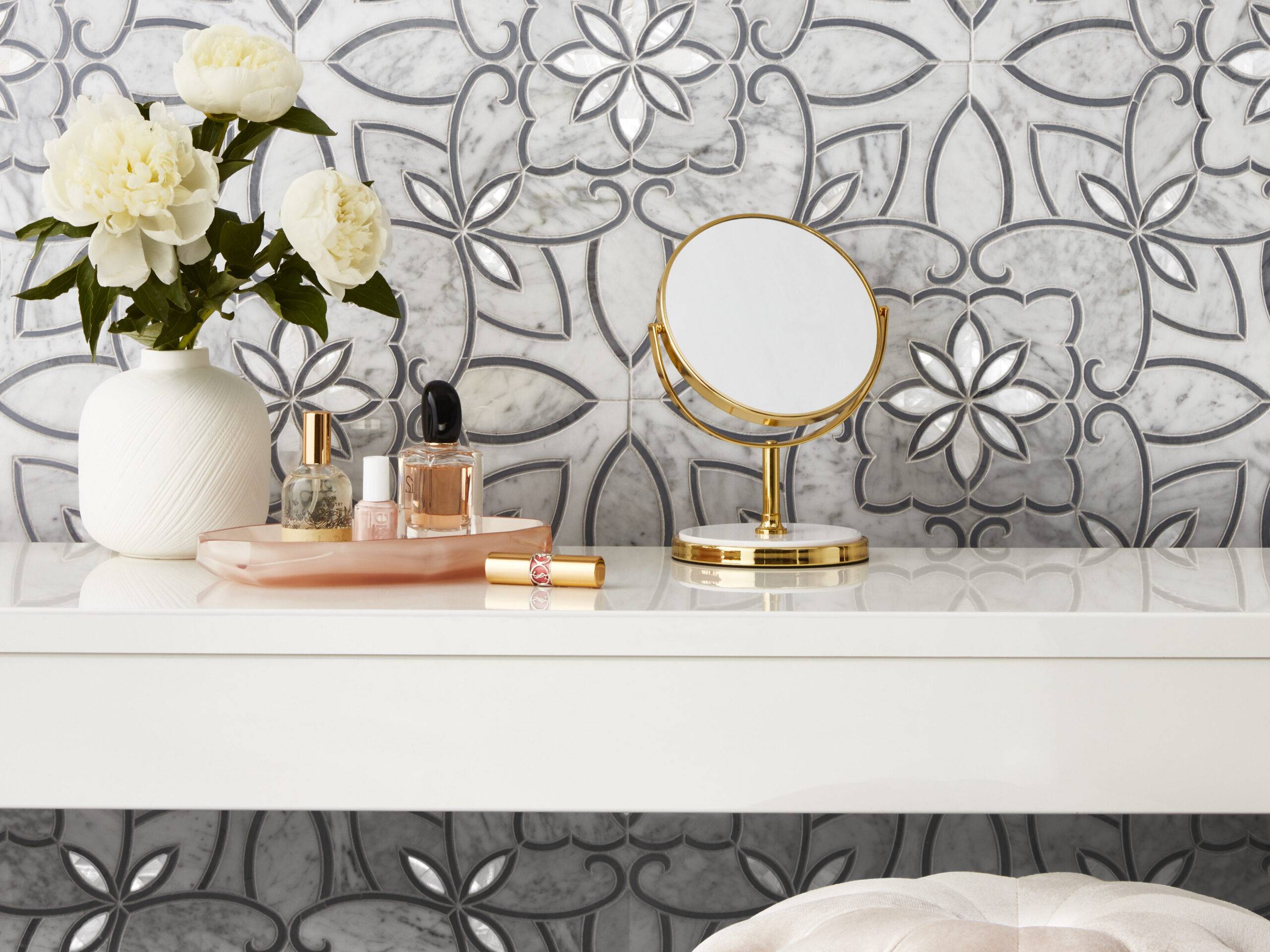 White marble mosaic with grey flower pattern on wall of elegant powder room.