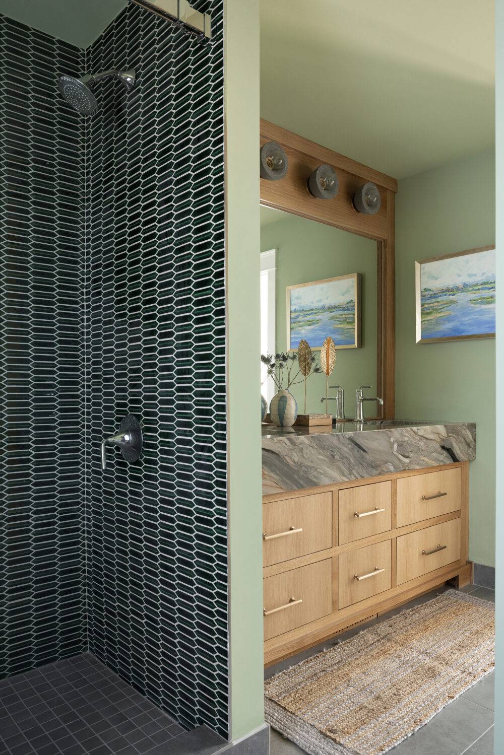 A modern green bathroom featuring a dark-green picket tile shower wall. 