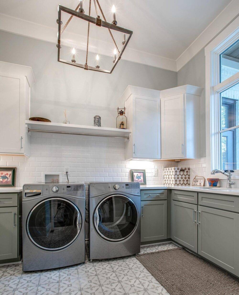 Laundry room featuring beveled subway wall tile and grey patterned floor tile.