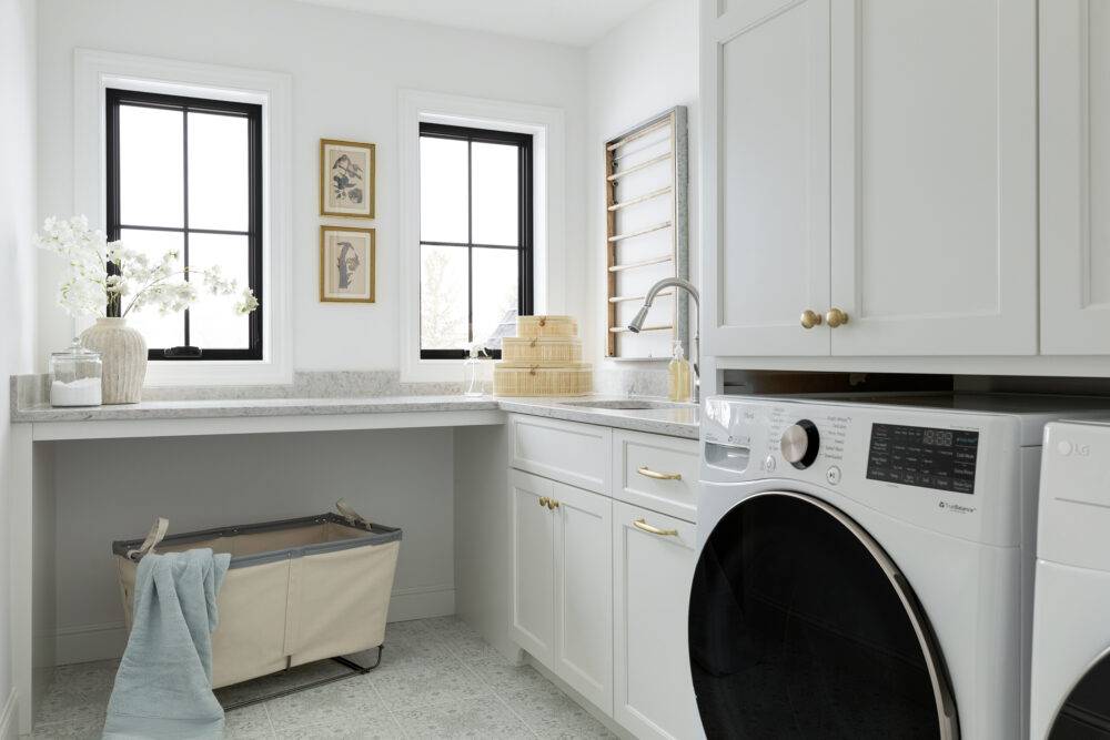 This crisp and clean laundry room features an ornate pattern tile floor.