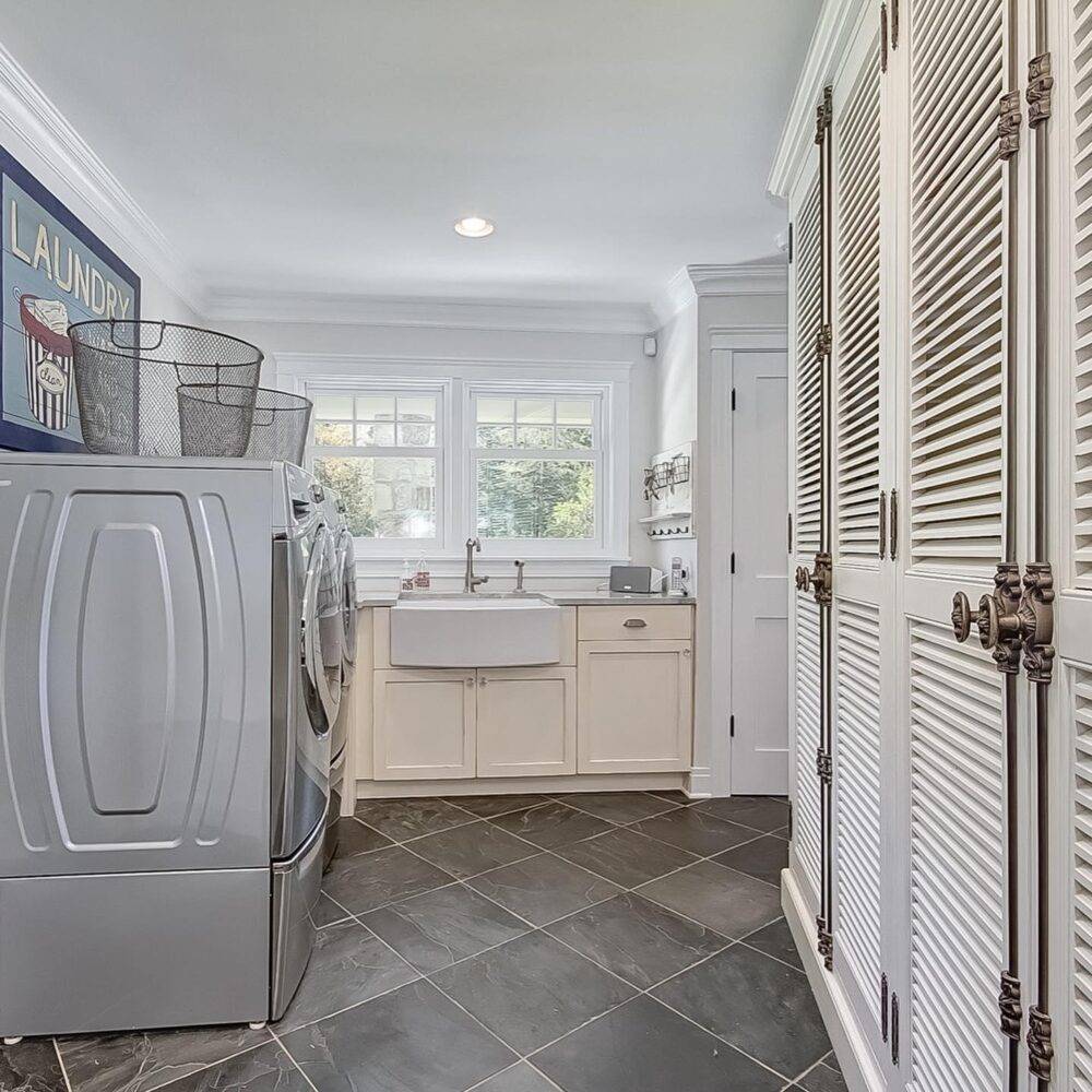 This laundry room features a grey slate tile floor. 