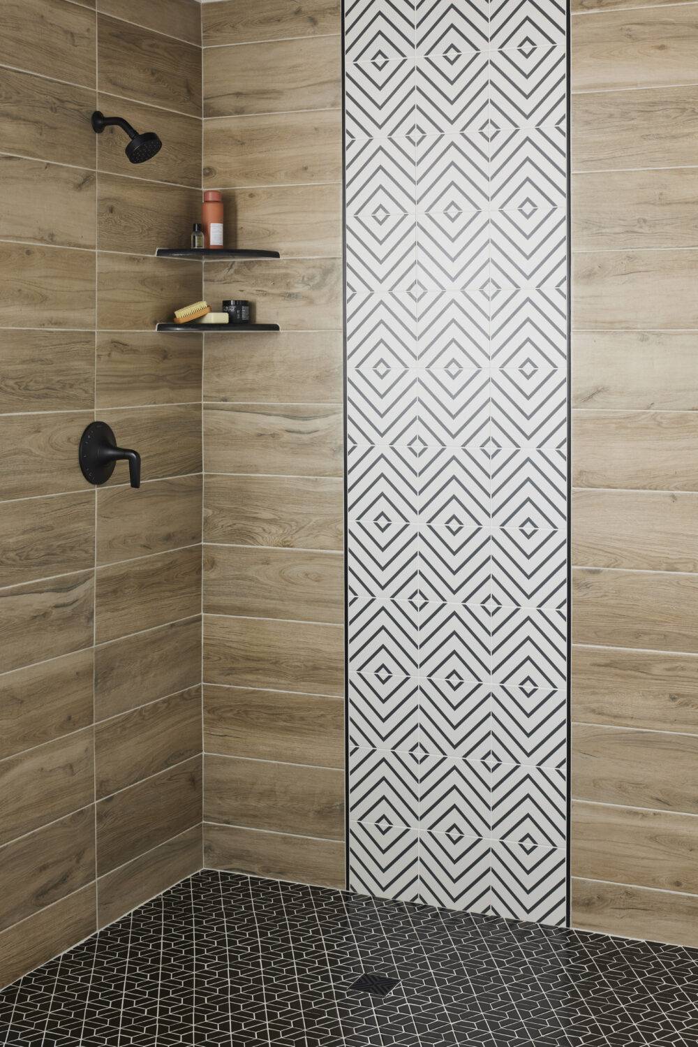This contemporary shower features wood-look porcelain tile and a band of white with black lined diamond-patterned tile and black  half-hexagon mosaic tile floor.