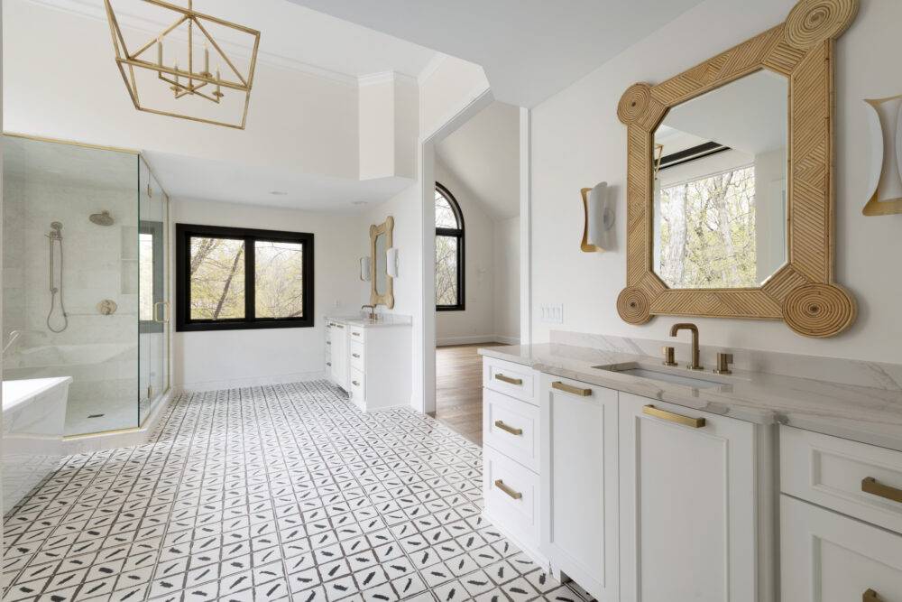 This large, bright bathroom features a patterned floor tile. 
