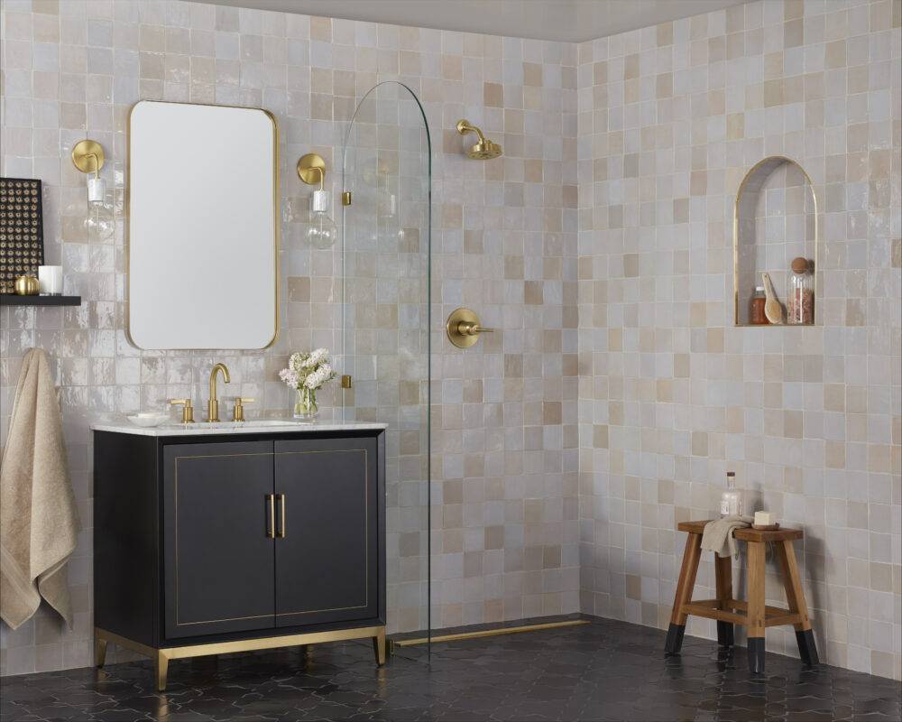 A bathroom with open shower featuring handmade Zellige tile on the walls and floors. 