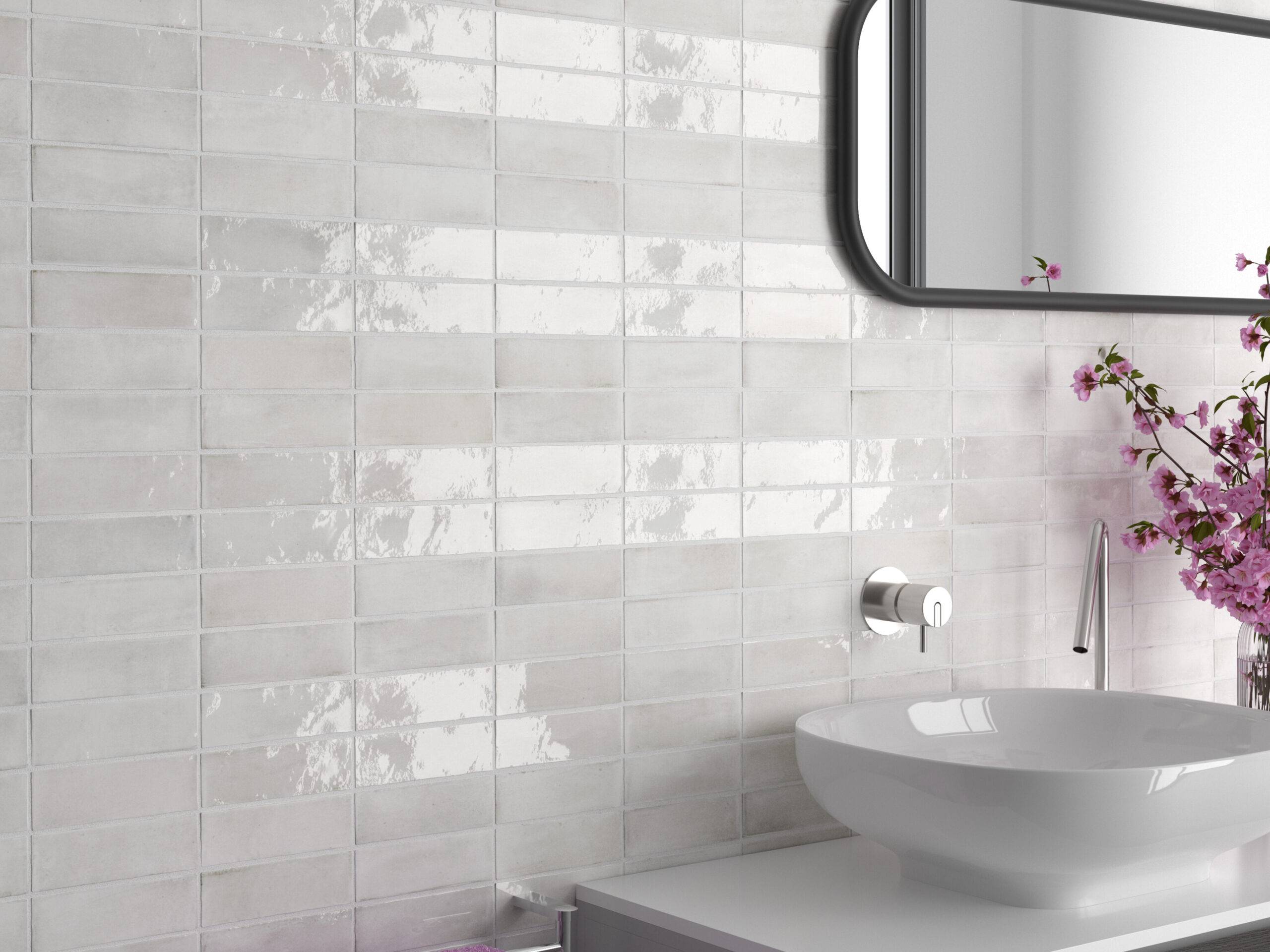 This bright and modern bathroom features handmade-look subway tile in stripes of matte and glossy finish.