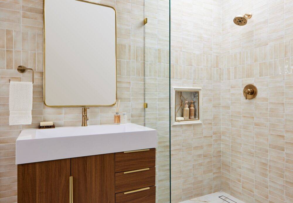 This bright modern bathroom features beige handmade-look subway tile. 