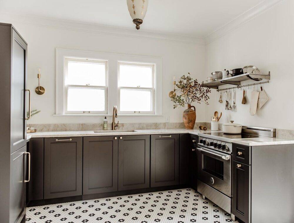 This modern farmhouse kitchen features a white with black flower hex tile floor. 